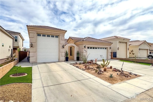 10730 S River Terrace Dr, Mohave Valley, AZ 86440 - mediterranean / spanish-style house featuring stucco siding, fence, a tile roof, an attached garage, and concrete driveway