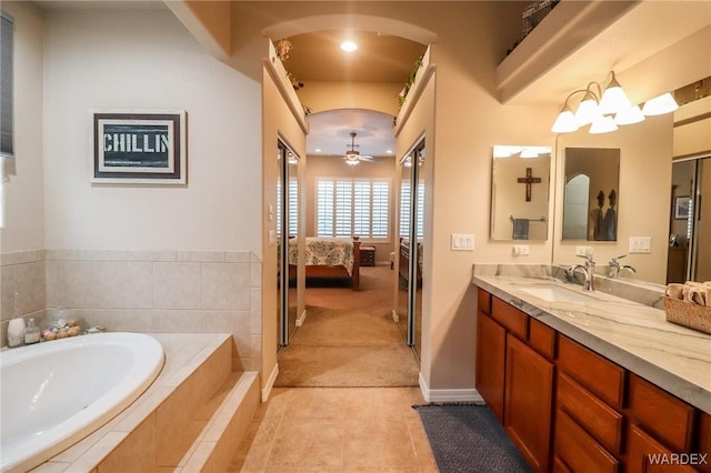 10730 S River Terrace Dr, Mohave Valley, AZ 86440 - full bathroom featuring a ceiling fan, connected bathroom, vanity, tile patterned flooring, and a garden tub