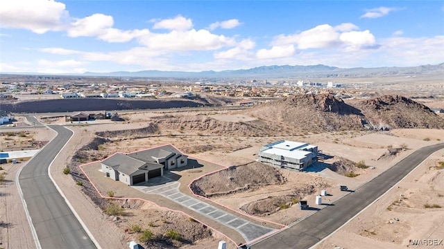 aerial view featuring view of desert and a mountain view