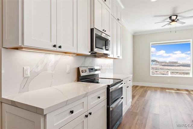 kitchen with stainless steel appliances, ornamental molding, light stone counters, and light wood-style floors