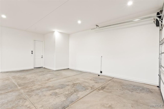 garage with recessed lighting and baseboards