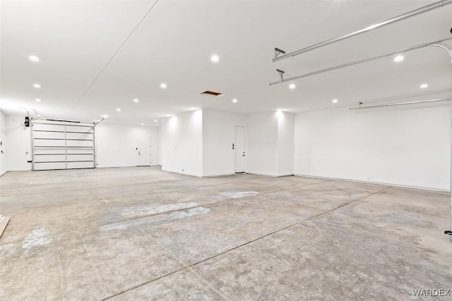 garage with baseboards, visible vents, and recessed lighting