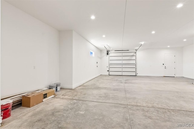 garage featuring baseboards and recessed lighting