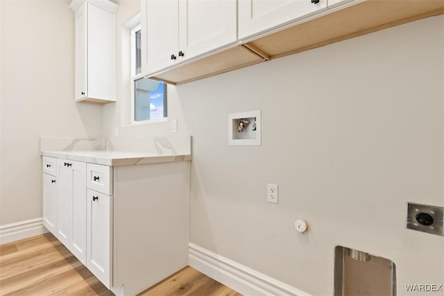 laundry area with cabinet space, baseboards, hookup for a washing machine, light wood-style floors, and electric dryer hookup