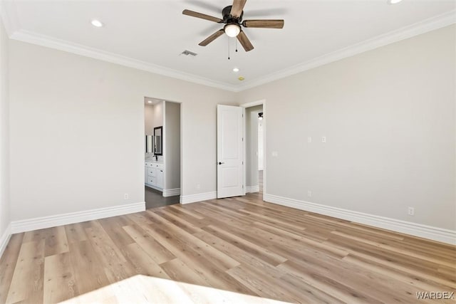 unfurnished bedroom with ornamental molding, visible vents, light wood-style flooring, and baseboards