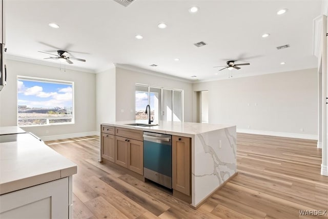 kitchen featuring dishwasher, a sink, visible vents, and crown molding