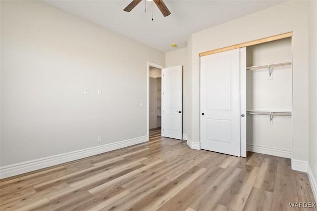 unfurnished bedroom featuring ceiling fan, a closet, wood finished floors, and baseboards