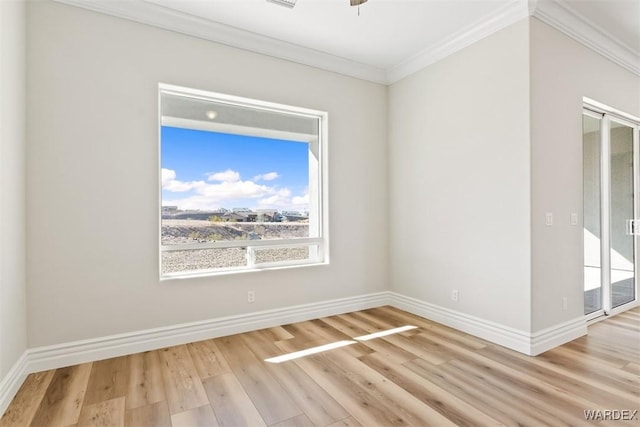 unfurnished room with ornamental molding, wood finished floors, a ceiling fan, and baseboards