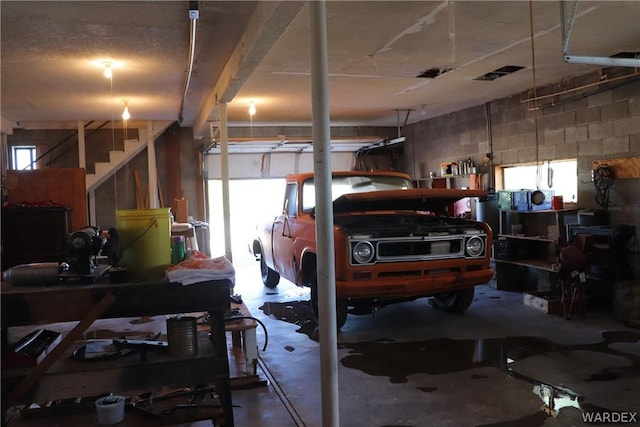 garage with concrete block wall