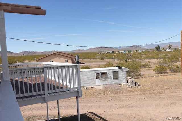 view of yard with a deck with mountain view