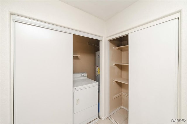 washroom with light tile patterned floors and washer / dryer