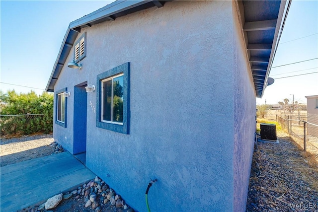 view of property exterior featuring fence and stucco siding