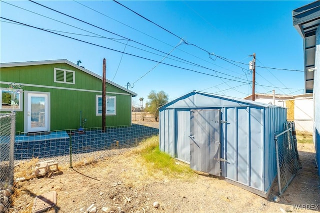 view of shed featuring fence