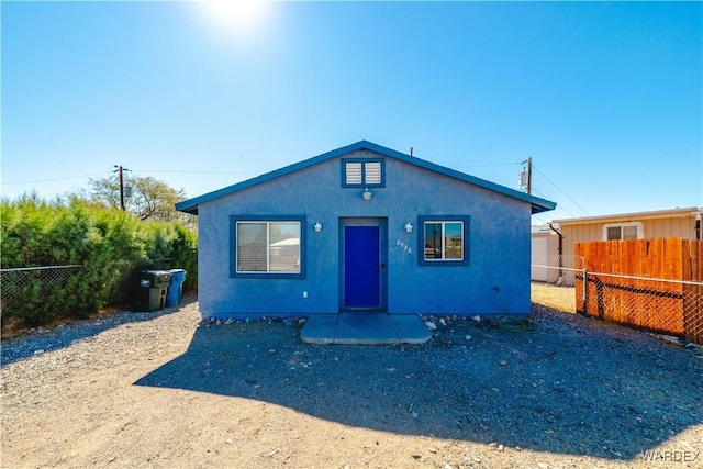 view of front of property featuring fence and stucco siding