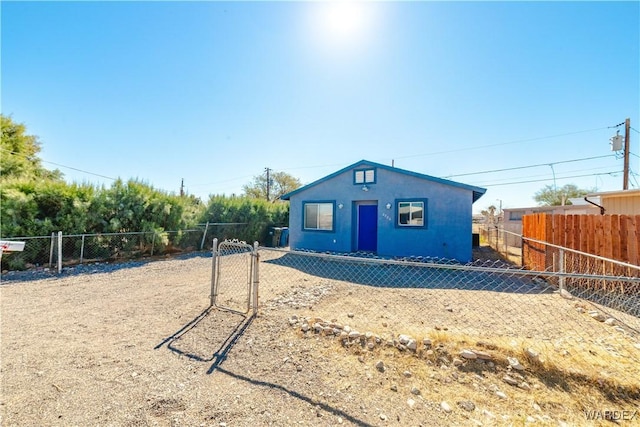 bungalow-style home featuring fence private yard and stucco siding