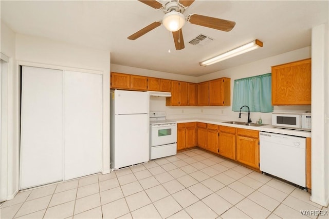 kitchen with visible vents, light countertops, a sink, white appliances, and under cabinet range hood