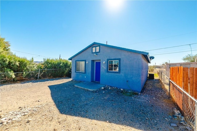 exterior space with a fenced backyard and stucco siding