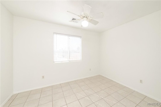 spare room with a ceiling fan and baseboards