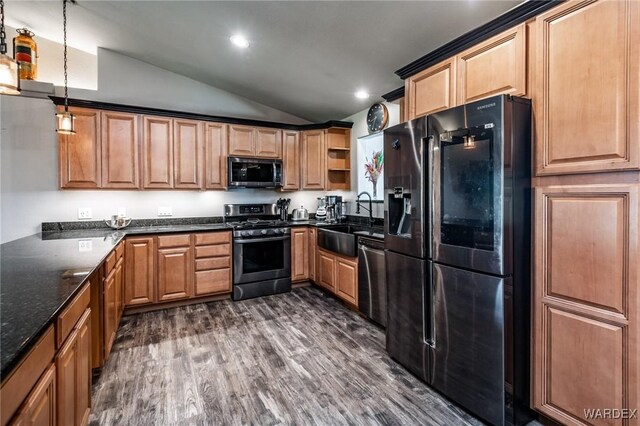 kitchen featuring lofted ceiling, dark wood-type flooring, stainless steel appliances, open shelves, and a sink