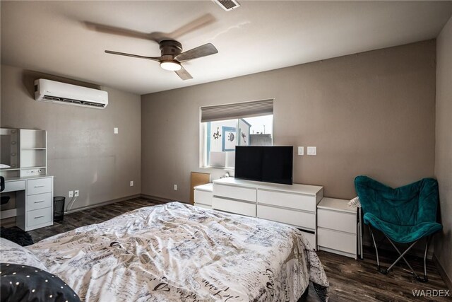 bedroom with a wall mounted AC, dark wood finished floors, a ceiling fan, and baseboards