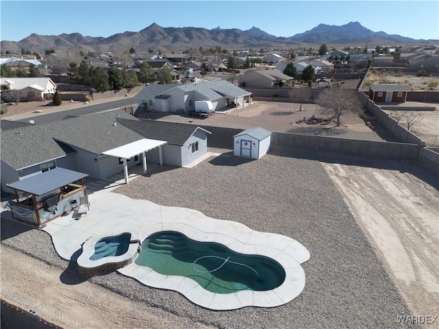 drone / aerial view featuring a residential view and a mountain view