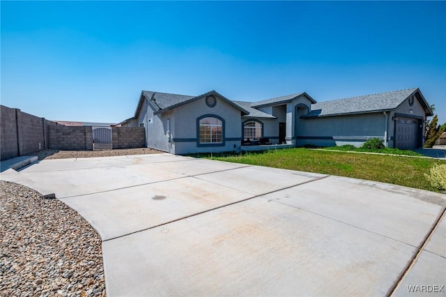 ranch-style house featuring driveway, stucco siding, a gate, fence, and a front yard