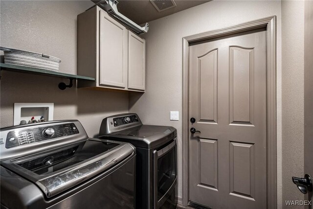 laundry room with cabinet space, visible vents, and independent washer and dryer