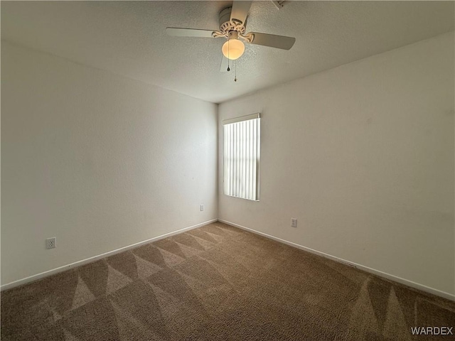 carpeted spare room featuring ceiling fan, a textured ceiling, and baseboards