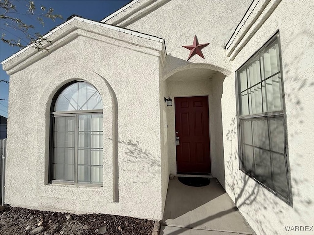 view of exterior entry with stucco siding