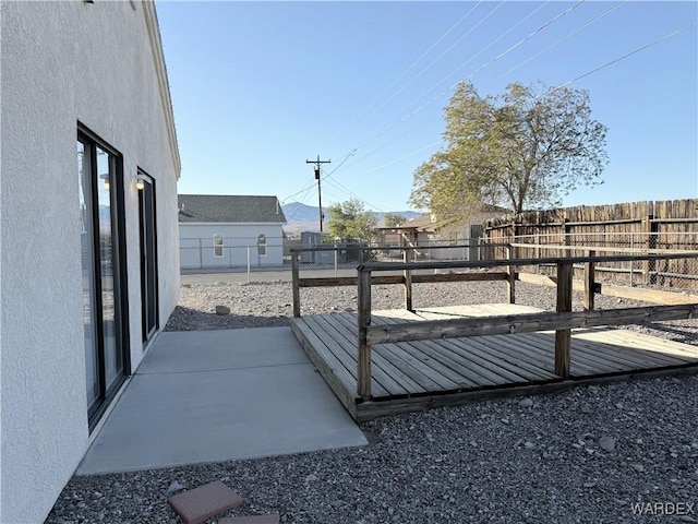 view of yard with a fenced backyard and a wooden deck