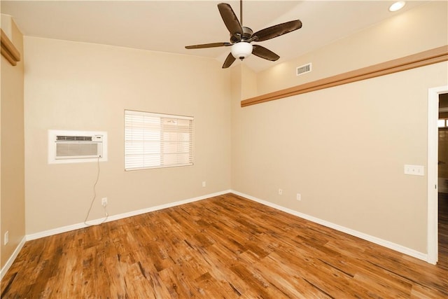 3059 Mallory Loop, Kingman, AZ 86401 - unfurnished room with a wall unit AC, wood finished floors, baseboards, ceiling fan, and recessed lighting