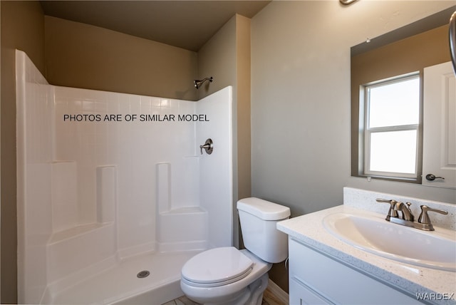 full bath with a shower, vanity, and toilet