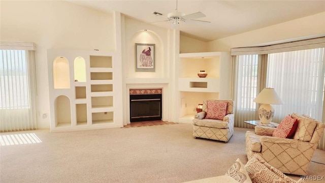 sitting room with light carpet, a fireplace with flush hearth, visible vents, and built in features