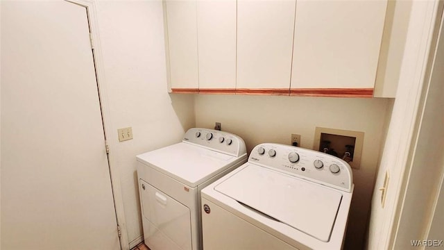 washroom with cabinet space and washing machine and dryer