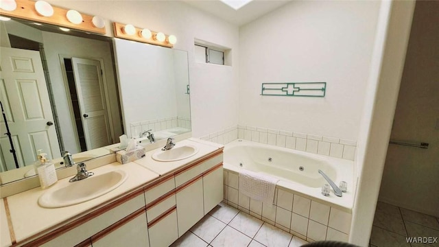 full bath featuring double vanity, a jetted tub, tile patterned flooring, and a sink