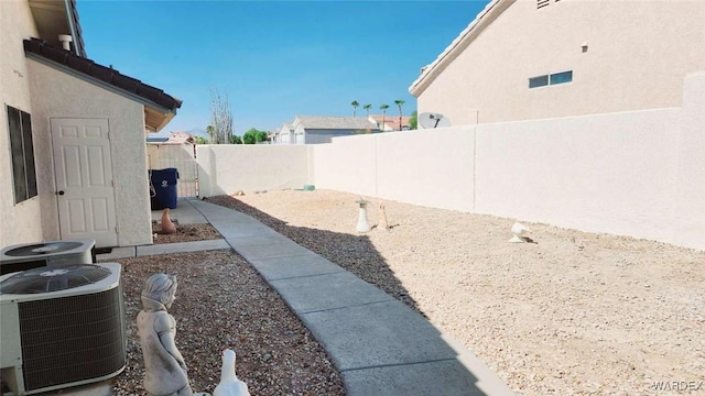 view of yard with a fenced backyard and cooling unit