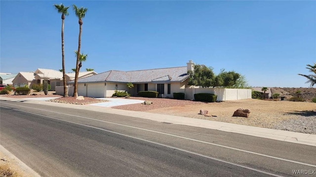 ranch-style home featuring stucco siding, fence, a garage, a residential view, and driveway