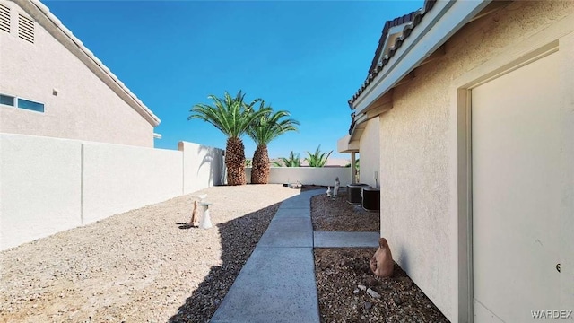 view of yard featuring a fenced backyard and central air condition unit