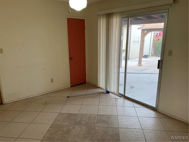 unfurnished room featuring light tile patterned floors