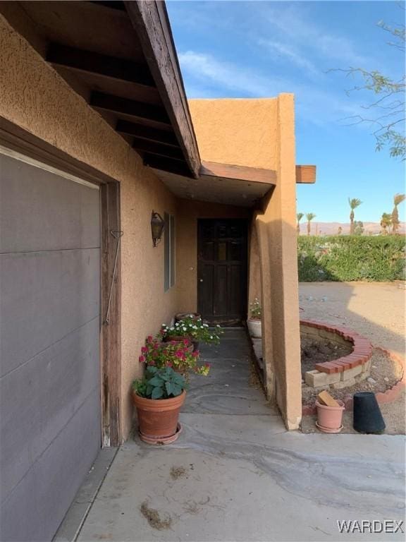 entrance to property with stucco siding