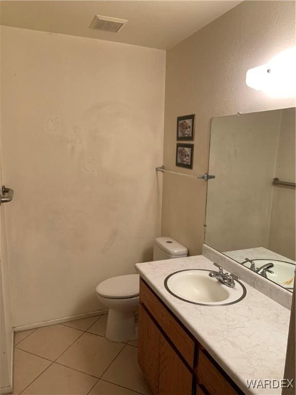 bathroom featuring toilet, vanity, visible vents, and tile patterned floors