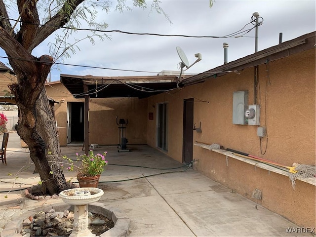 back of house with a patio area and stucco siding