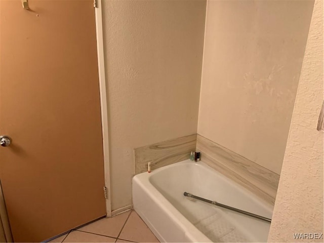 full bathroom featuring a bath and tile patterned floors