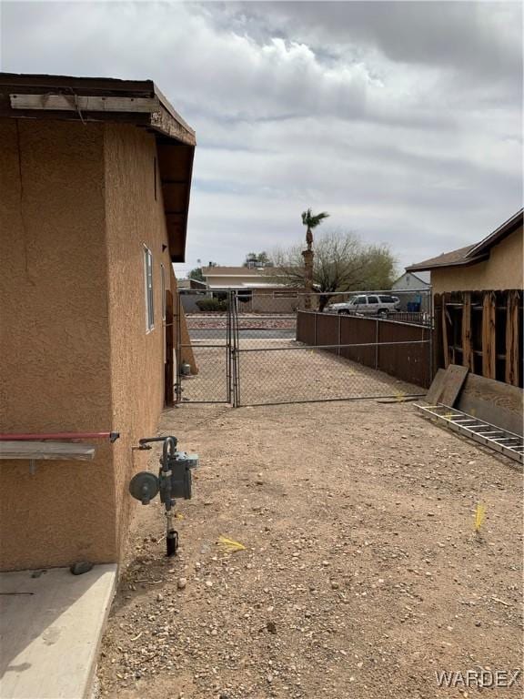 view of yard featuring fence and a gate