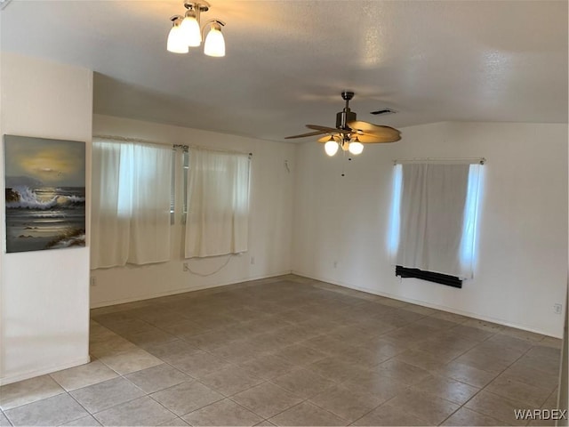 unfurnished room featuring baseboards, visible vents, and a ceiling fan