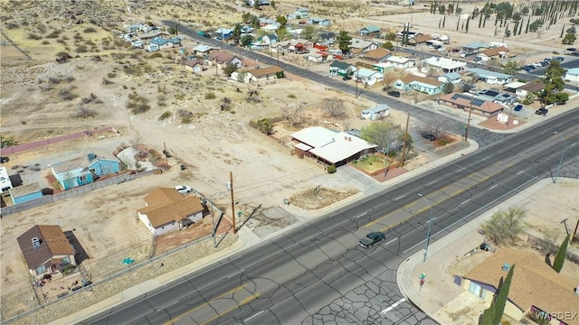 drone / aerial view featuring view of desert and a residential view