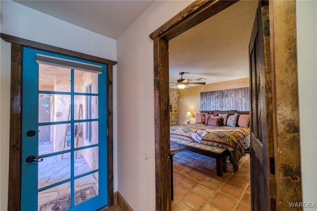 bedroom featuring a ceiling fan and a textured ceiling