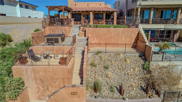 exterior space with a patio area, fence, and stairs