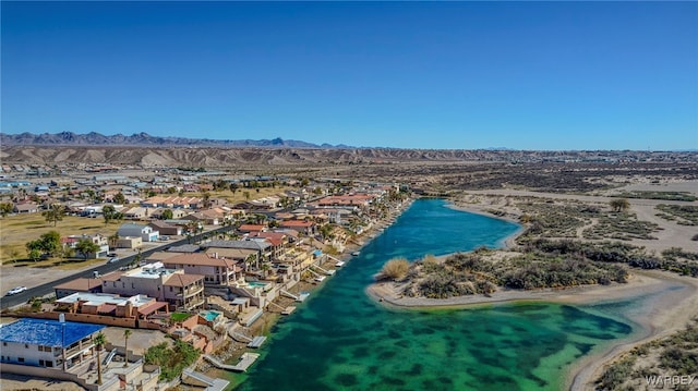 drone / aerial view featuring a water and mountain view