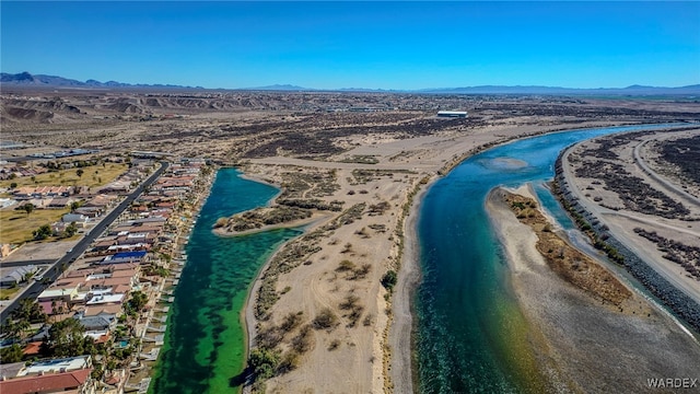 birds eye view of property featuring a water and mountain view